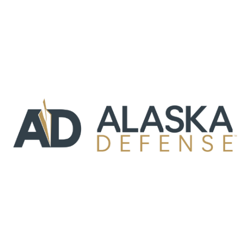 Logo of Alaska Defense featuring bold initials "AD" in dark gray with a gold accent, followed by the text "ALASKA DEFENSE" in uppercase.